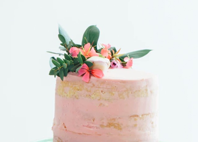 cream layered cake with floral and herb decoartion 